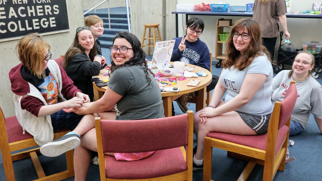 Students gathered around a table doing low-key crafts