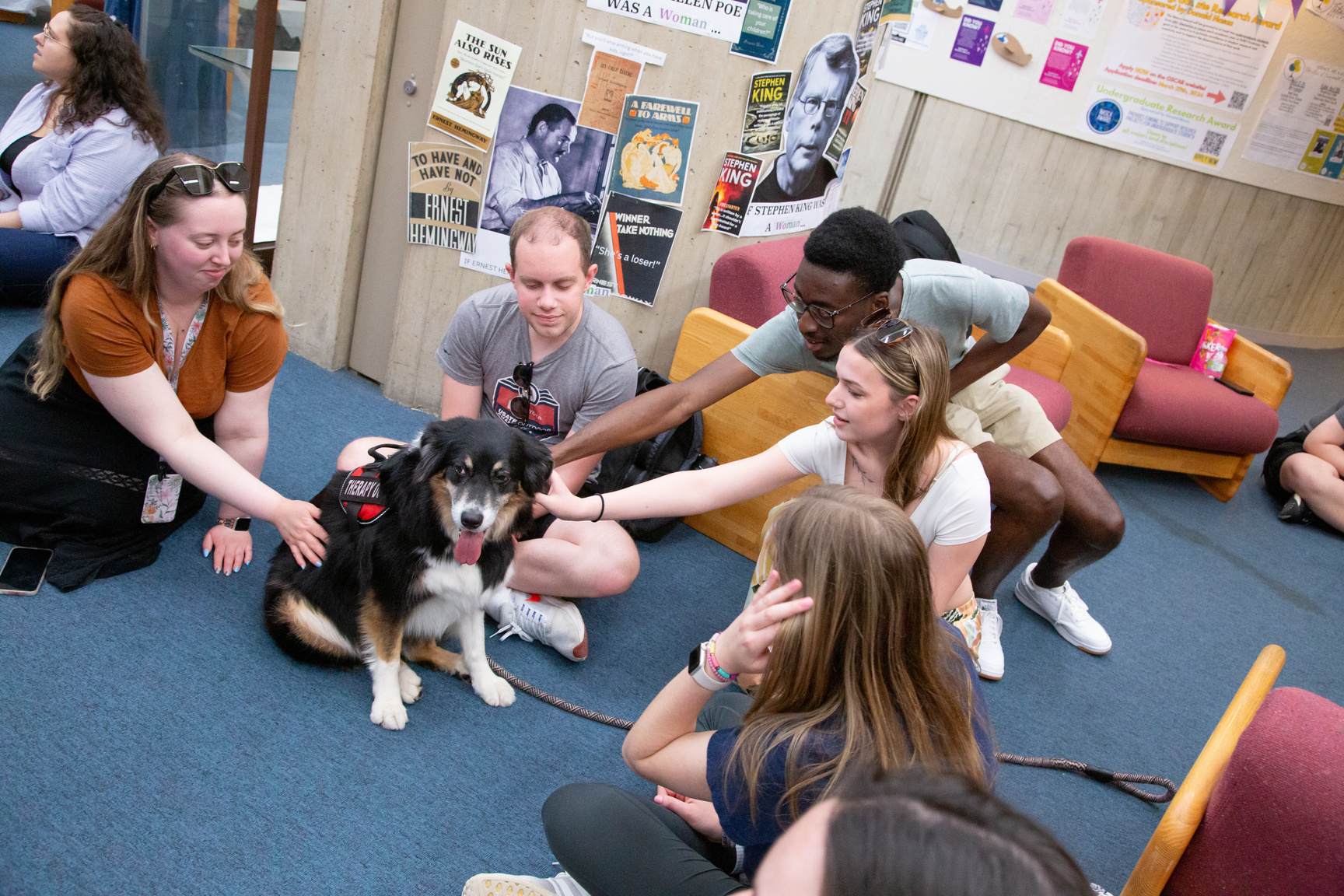 Students petting a therapy dog
